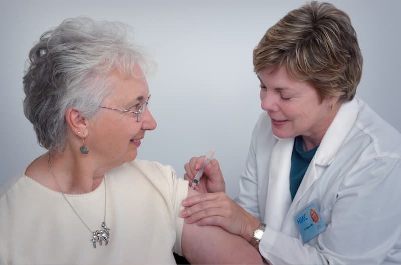 Caregiver helping elderly patient at home